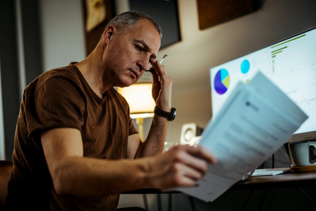 middle aged man serious looking at documents gettyimages