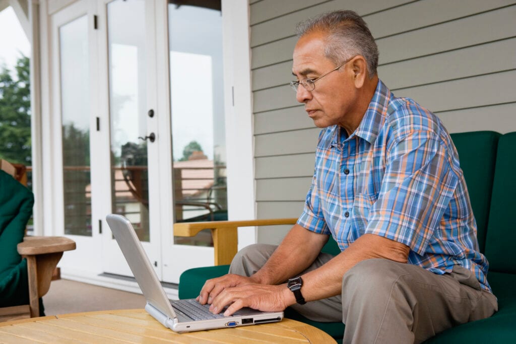 older man laptop outdoors gettyimages