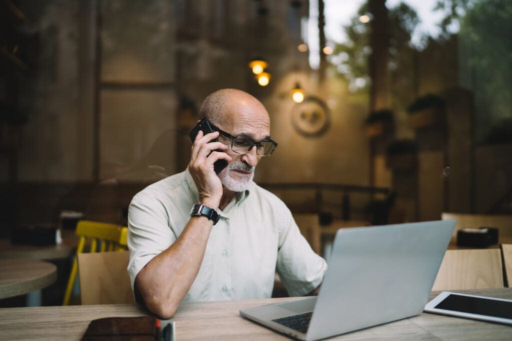 older man laptop phone upset gettyimages DKKnZ