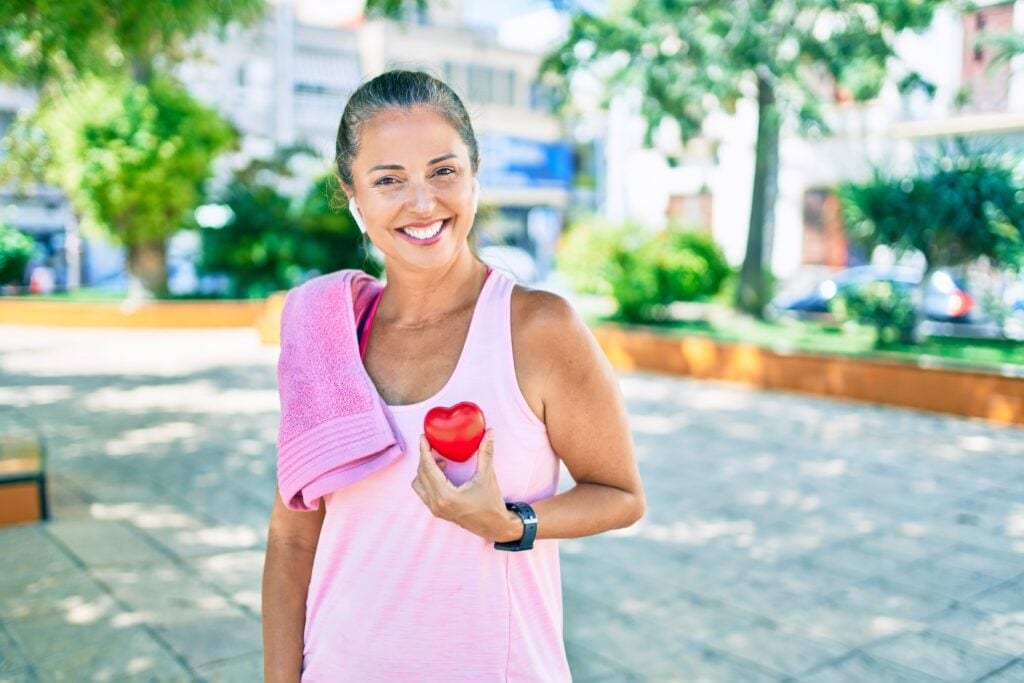 older woman exercise heart rate outdoor towel airpod cardio rJXTA