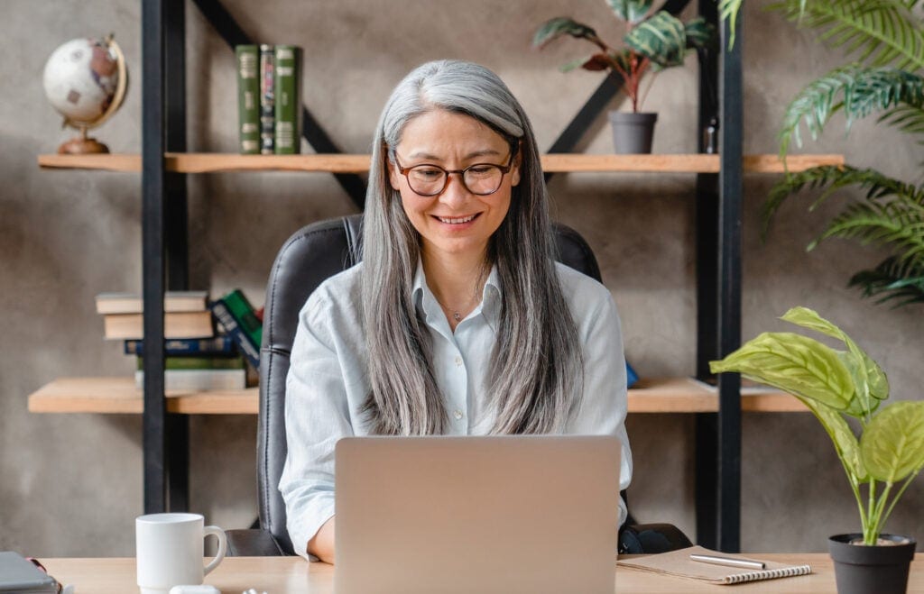 older woman laptop smiling gettyimages