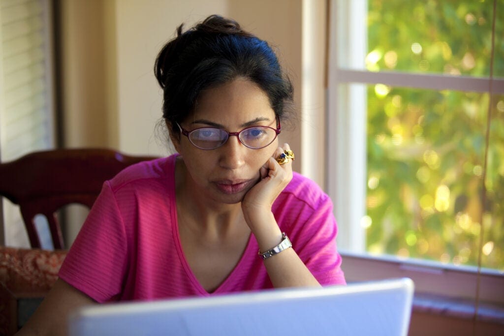 person reading on laptop