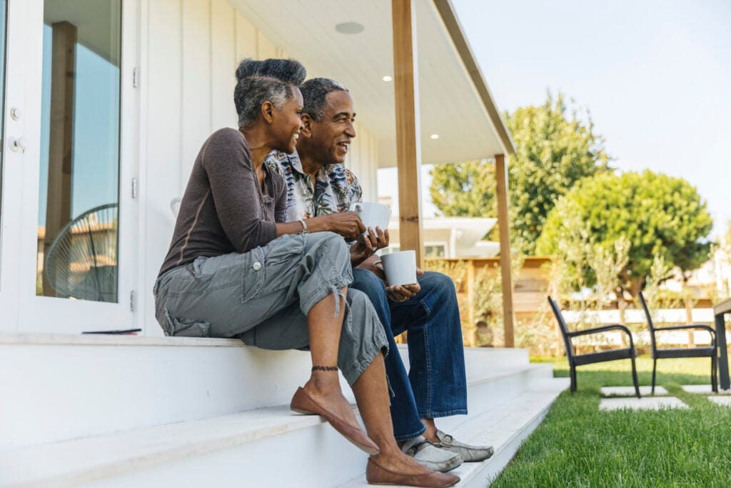 smiling couple sitting on a porch