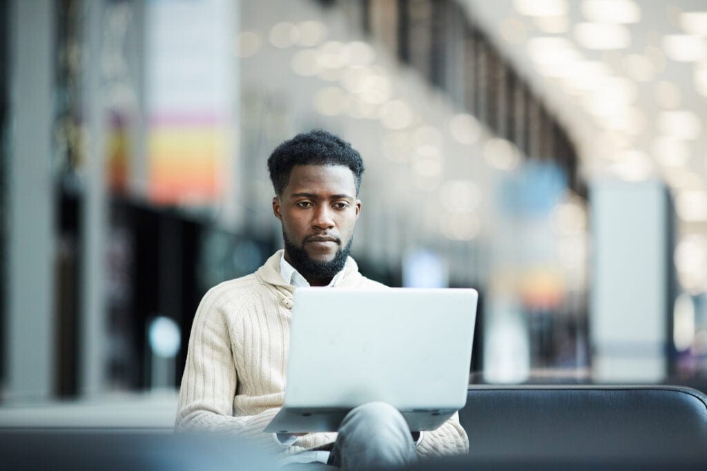 a person with a serious expression at a laptop gettyimages