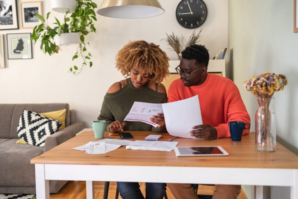 couple reviewing papers budgeting
