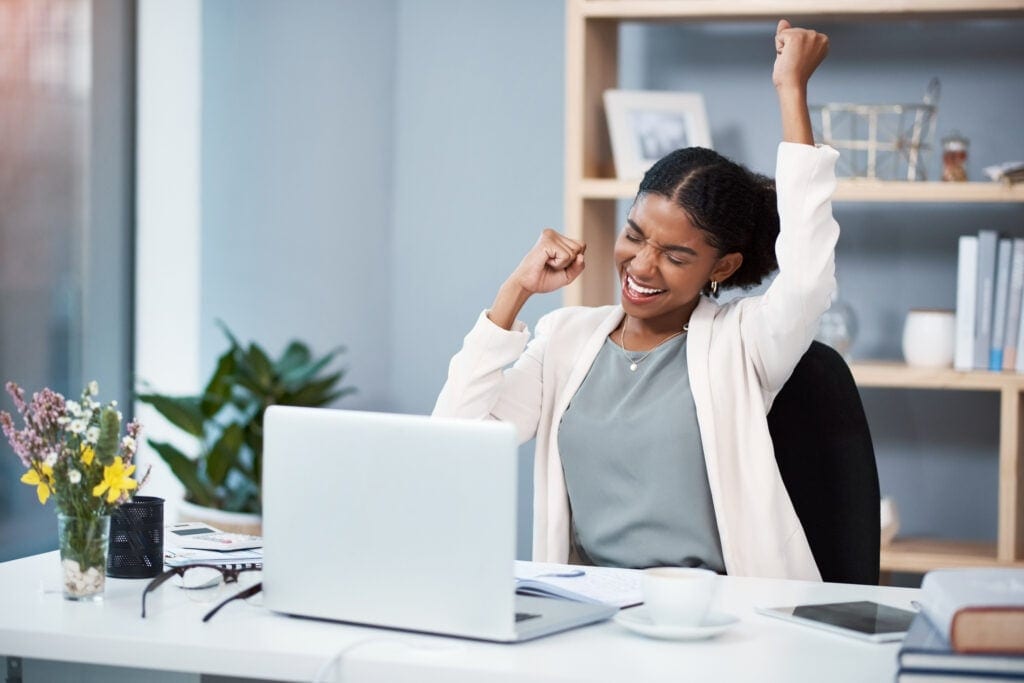 happy person celebrating at desk