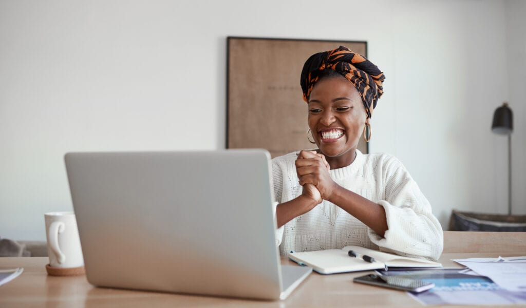 happy person looks at computer