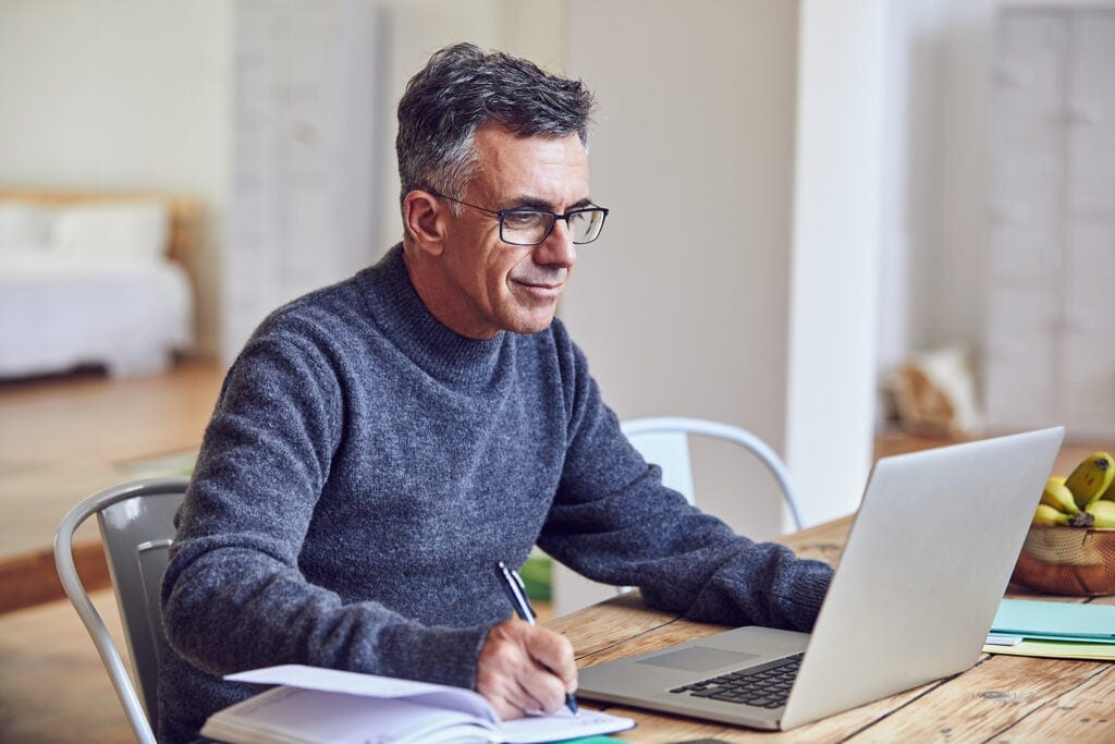 middle aged man notes laptopgettyimages