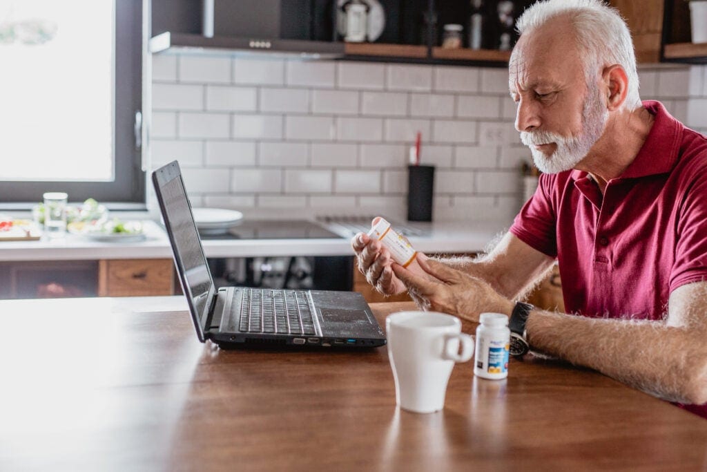 older man pills laptop gettyimages