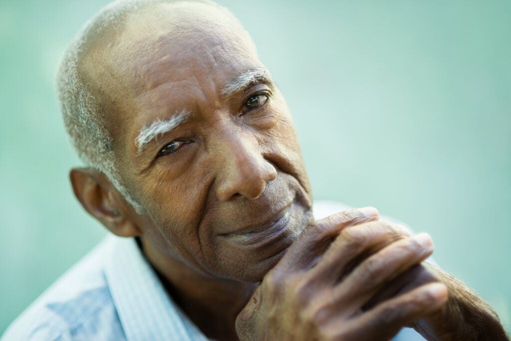 senior staring at camera while pondering getty