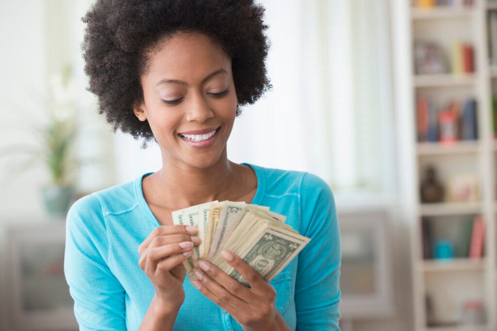 smiling person counting money