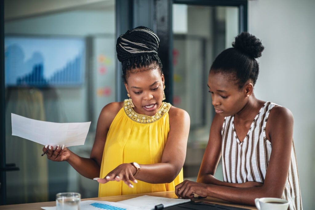 two coworkers discussing a document
