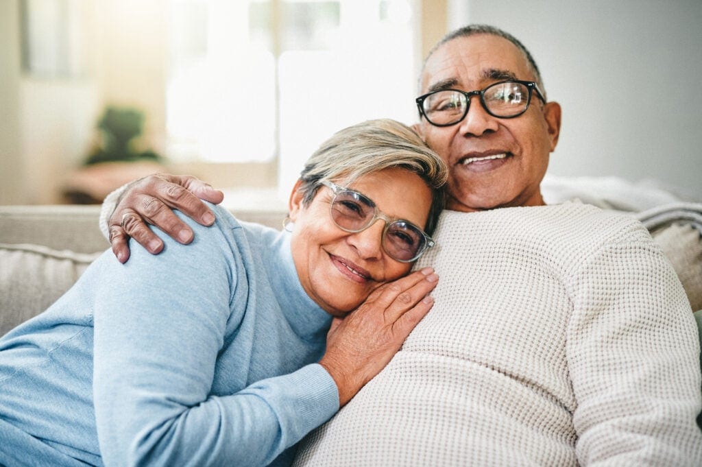 couple smiling on couch close together