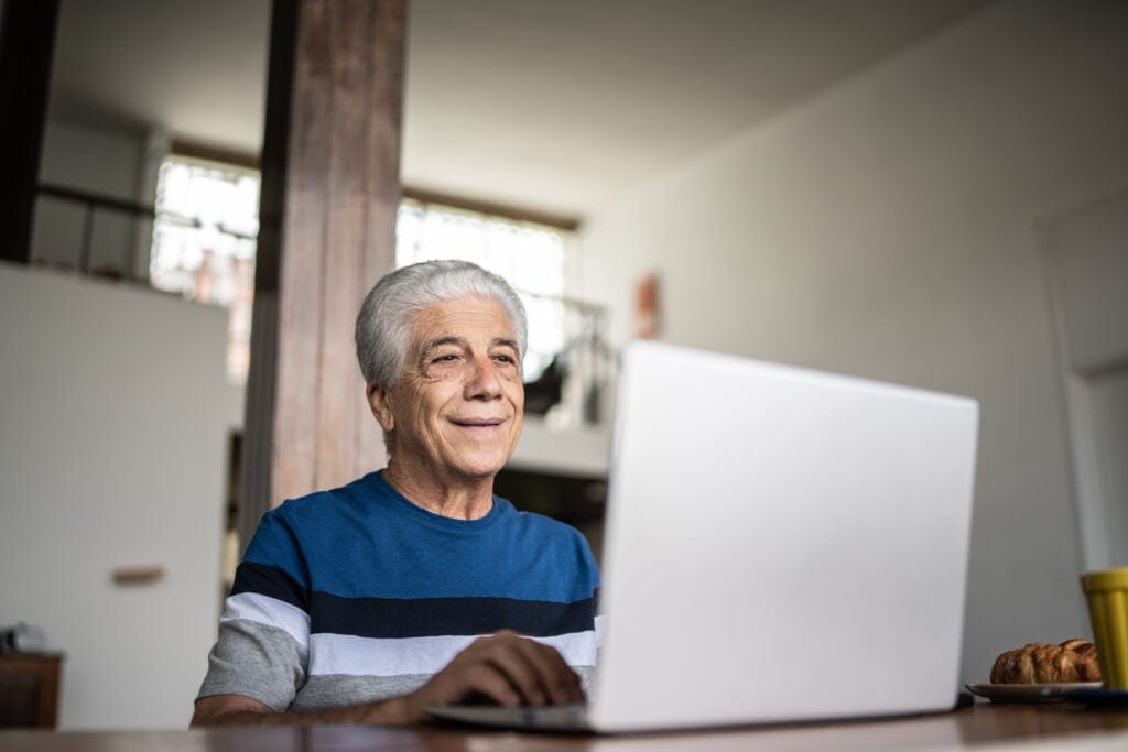 senior laptop smiling gettyimages