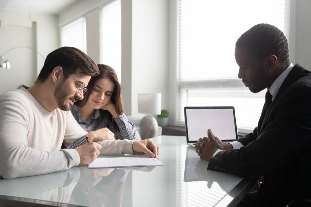 Couple signing paperwork with an agent ooiUfy.width