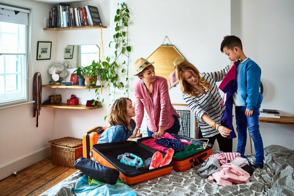 Family with kids packing for vacation qbaFuUl.width