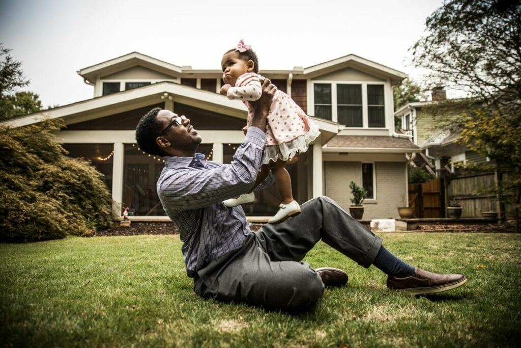 Father and toddler daughter play in homes bac.width leyKMuB