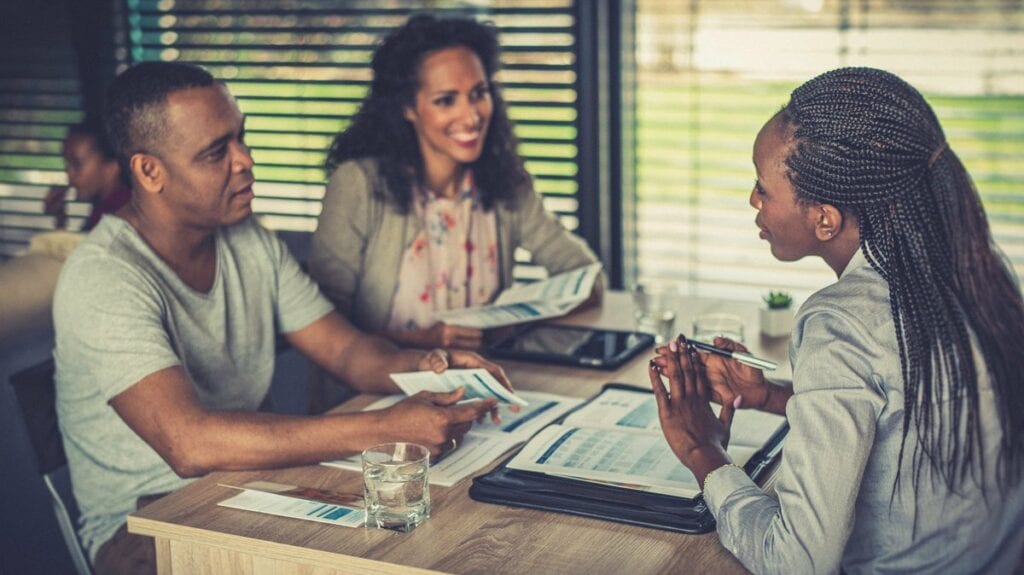 Financial professional talk to couple over pa.width vnBHhU