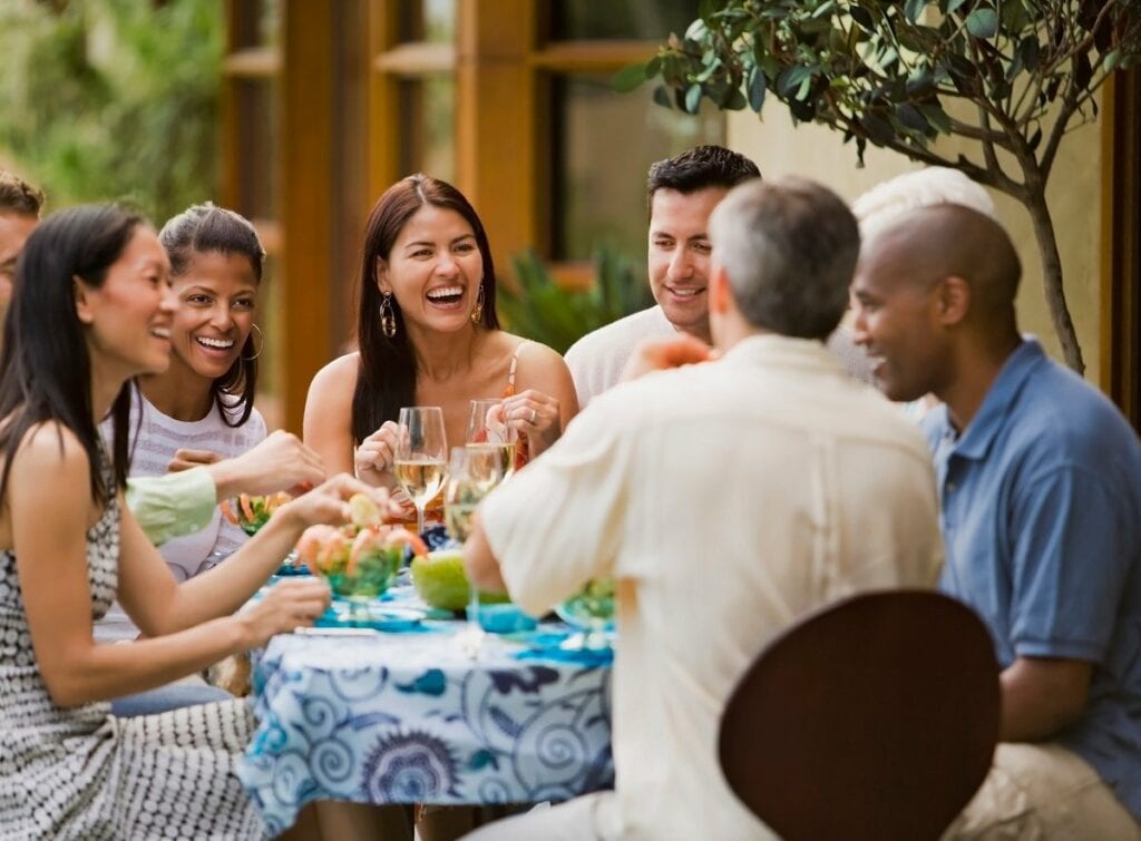 Group of friends dining on restaurant patio t.width