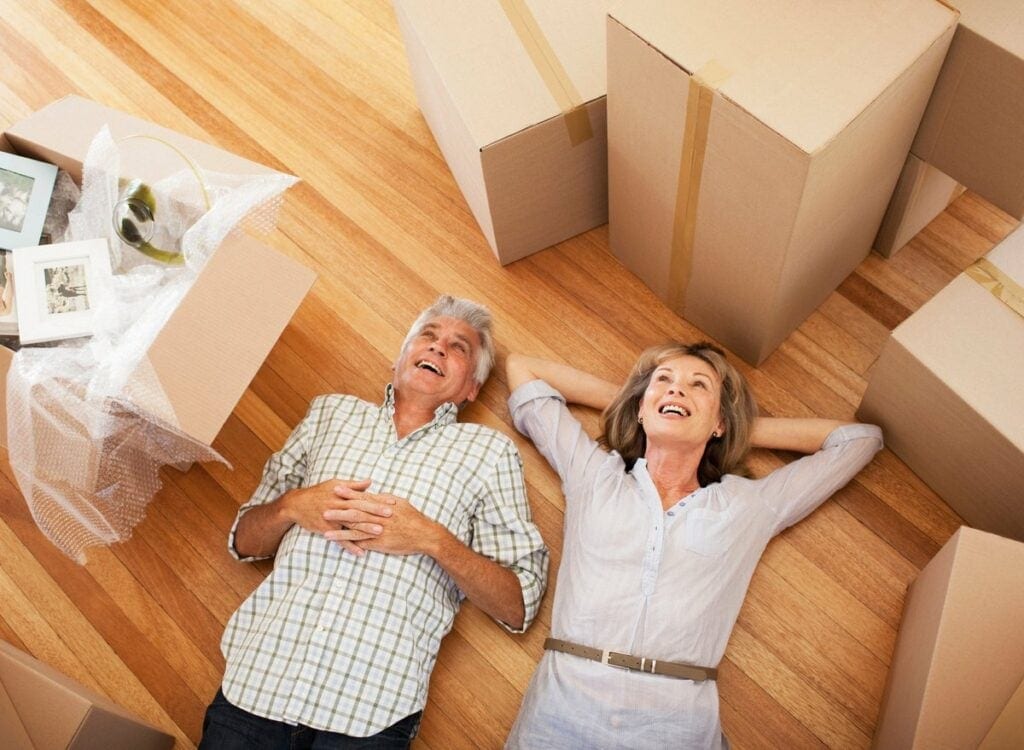Happy mature couple laying on the floor surro.width rNWebku.jpg