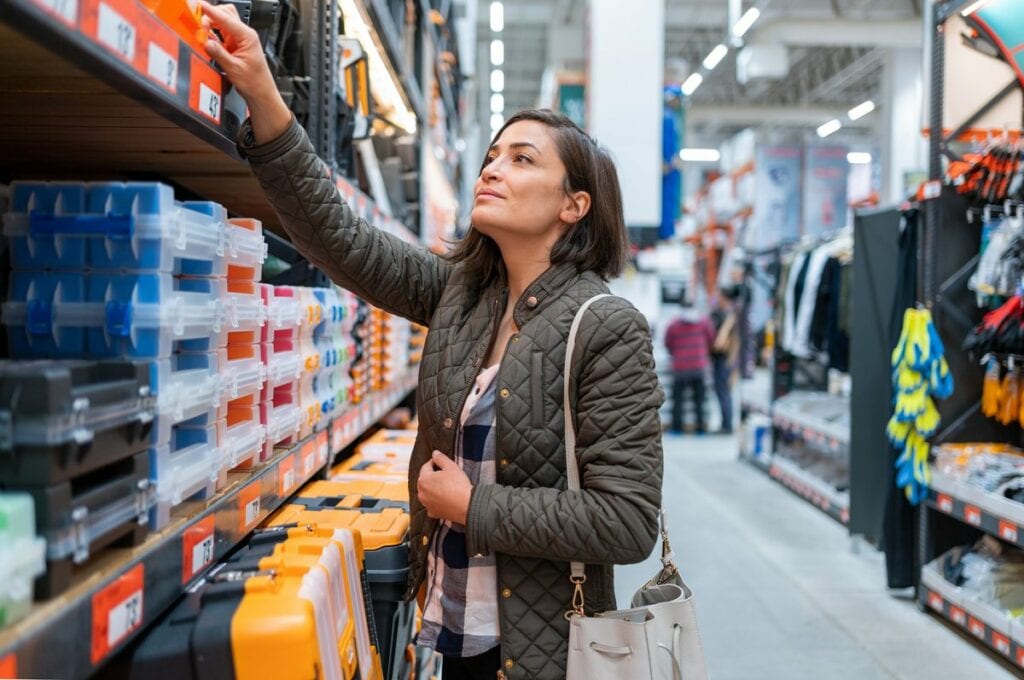 Shopper inspecting items in home improvement .width