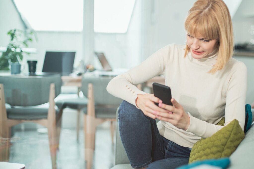 Woman uncomfortable by what shes reading on h.width InPJRqv
