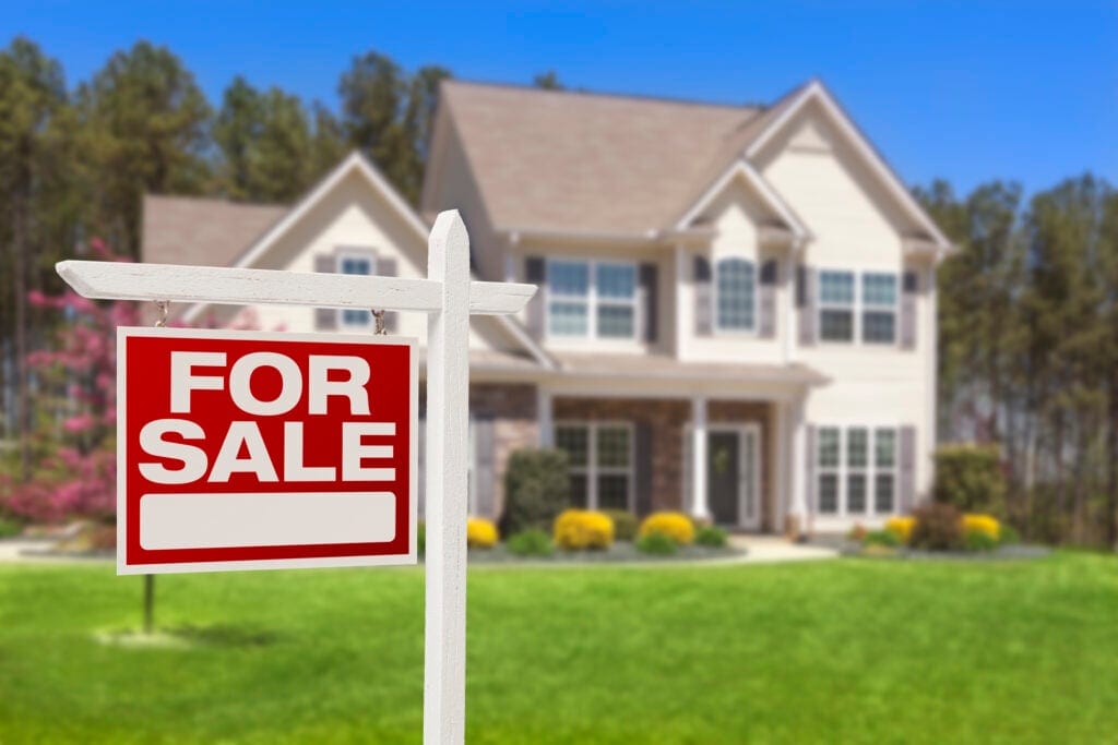 a house with a for sale sign in front gettyimages