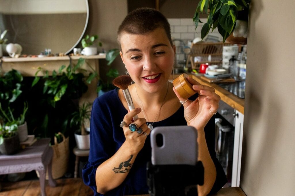 person holding makeup while recording on phon.width CHWzapr
