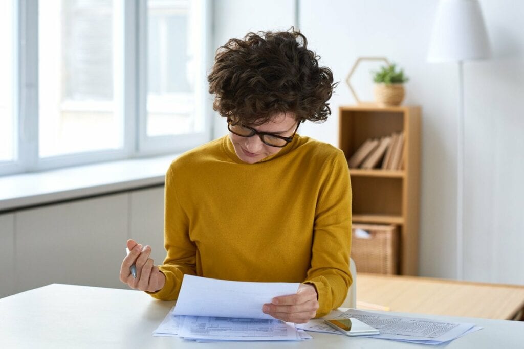 person with pen and paperwork RhgBV.width