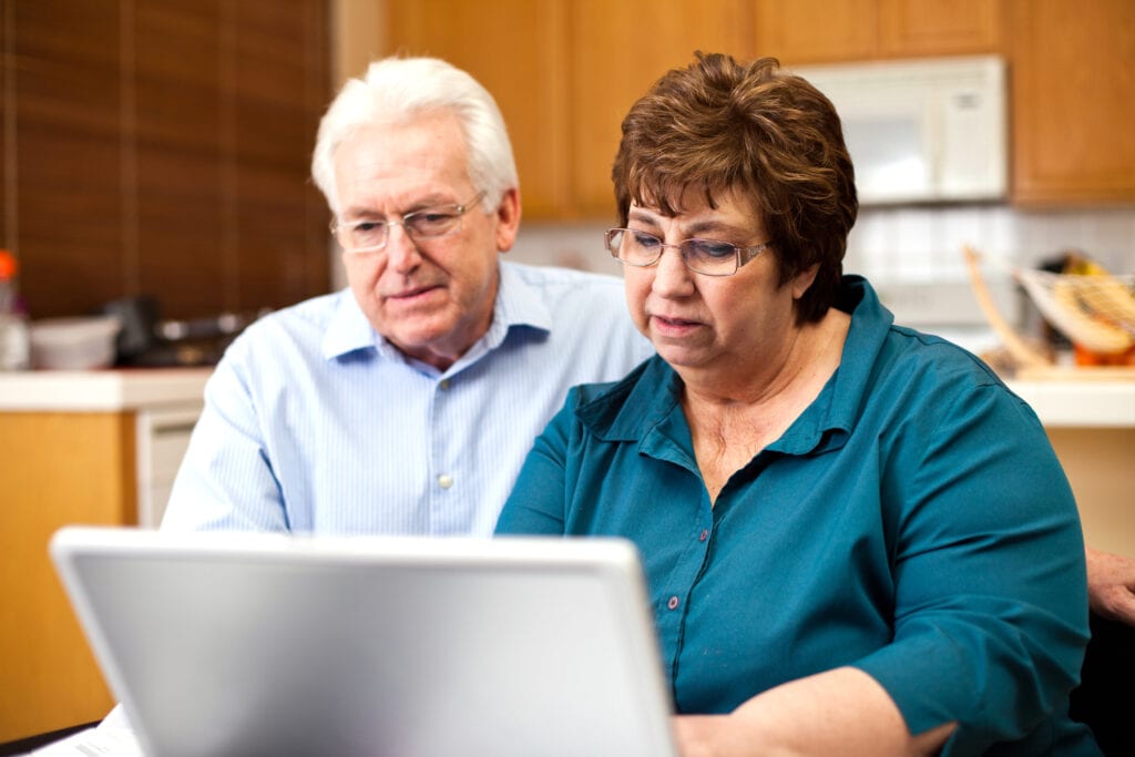 senior couple serious at laptop gettyimages