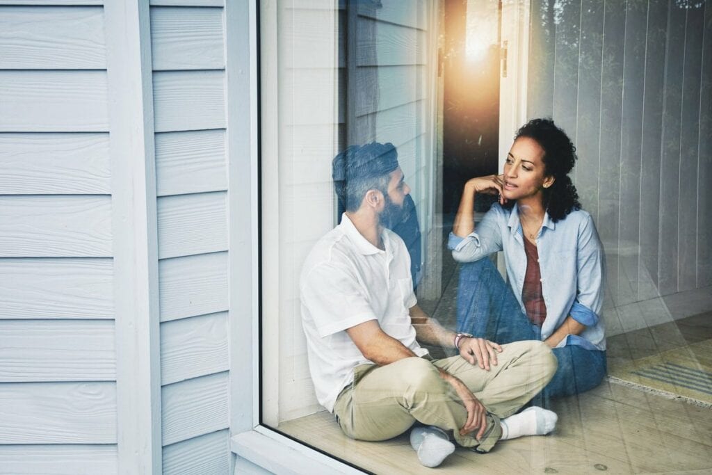 two people sitting on the floor and talking n.width IwLAY