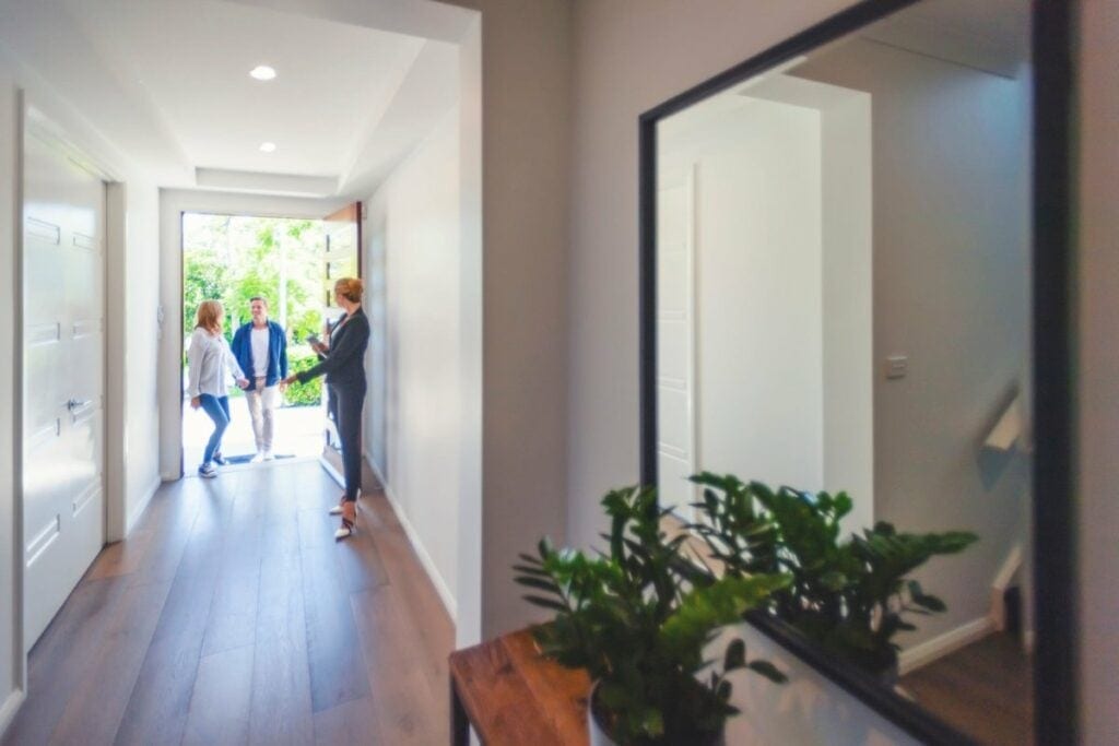 two people walking into house with realtor hd.width