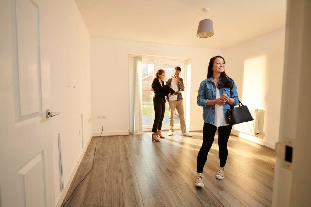 two people with realtor in empty house NVSf.width