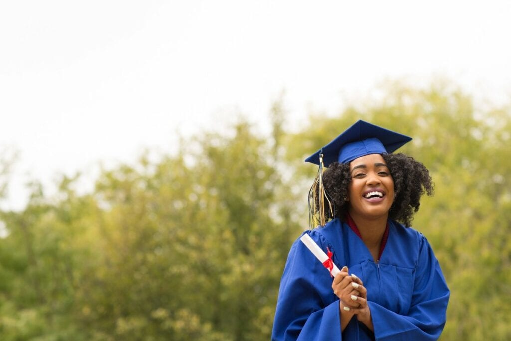 young smiling woman on graduation day wearing.width