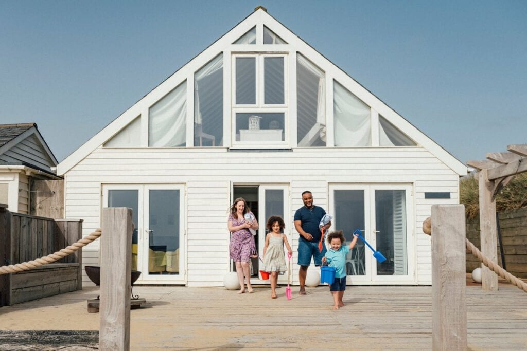 Family emerging from a beach house wvTXk.width .jpg