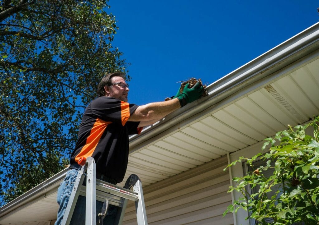 Man cleaning homes gutters fPDNzI.width .jpg