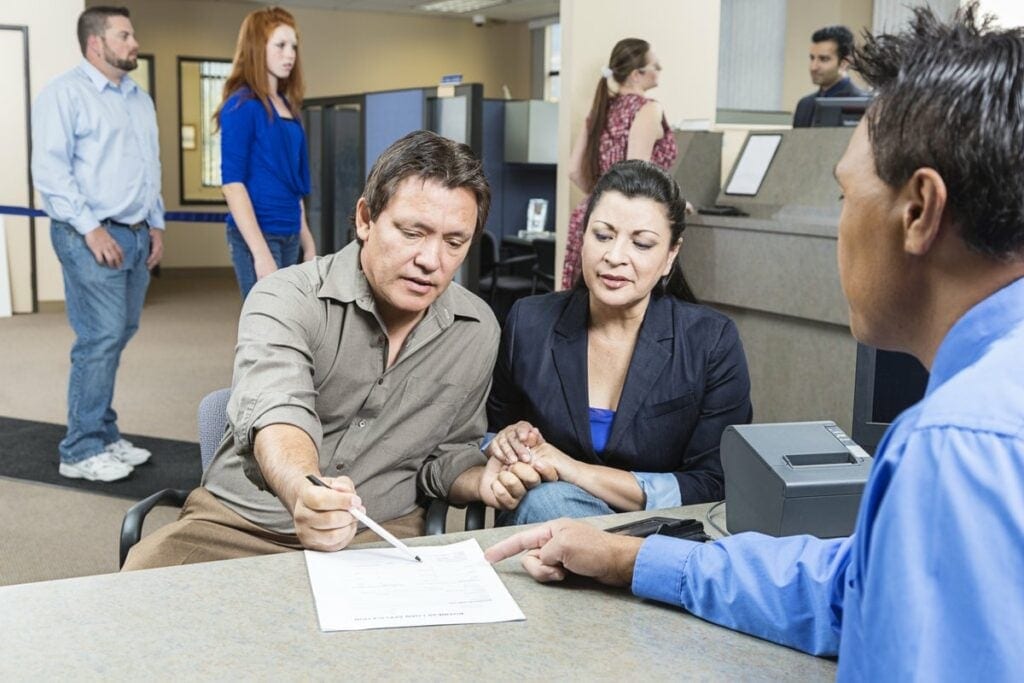 Native American couple looks over documents w.width .jpg