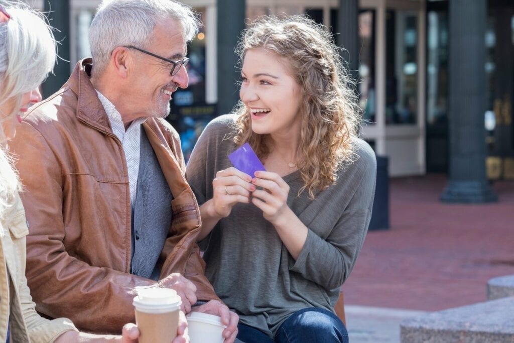 Parents giving credit card to excited teen da.width FXkOfK.jpg