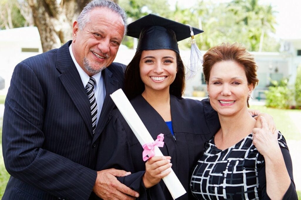Parents with college student at graduation .width hEWEQM.jpg