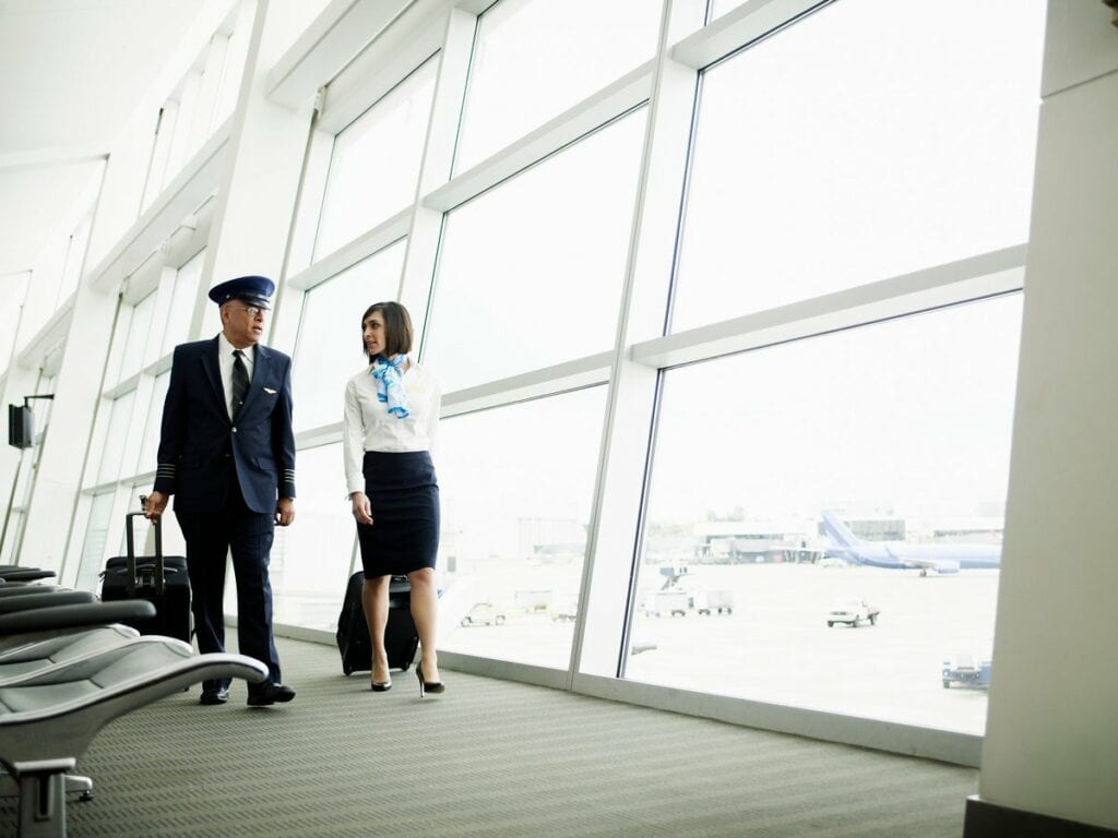 Pilot and flight attendant walking to airport.width LhaGV.jpg