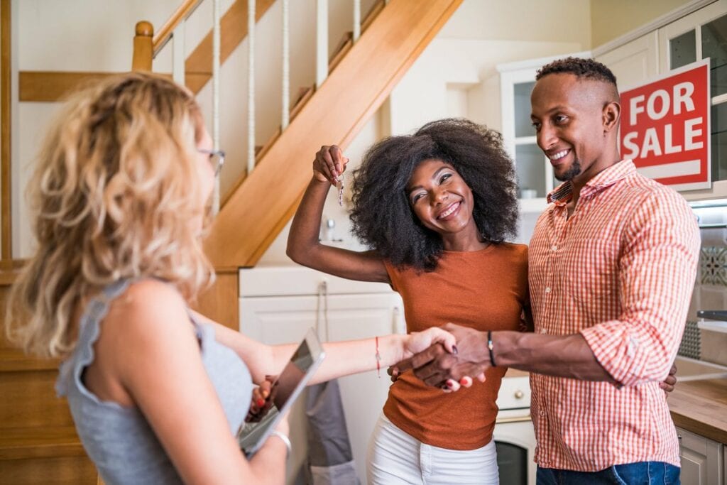 Real estate agent congratulating a new owner .width GeGttL.jpg