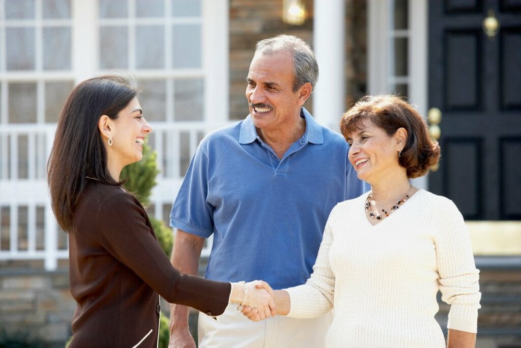 Realtor shaking hands with mature couple outs.width dGtEi.jpg