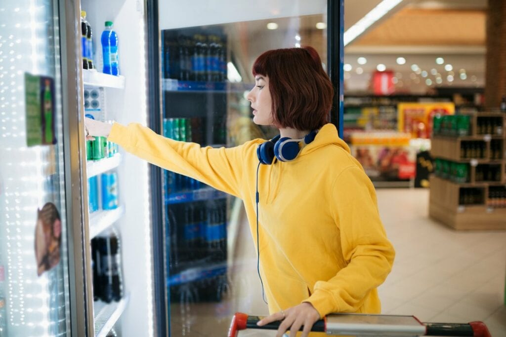 Shopper selecting beverage from a drink coole.width .jpg
