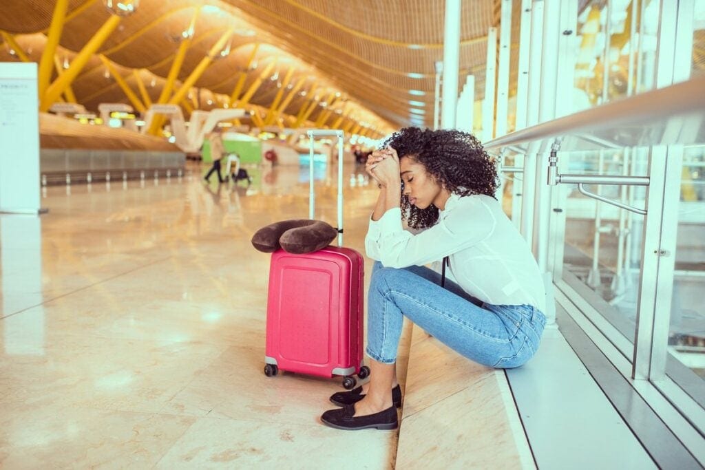 Upset woman at airport eSPPDv.width .jpg