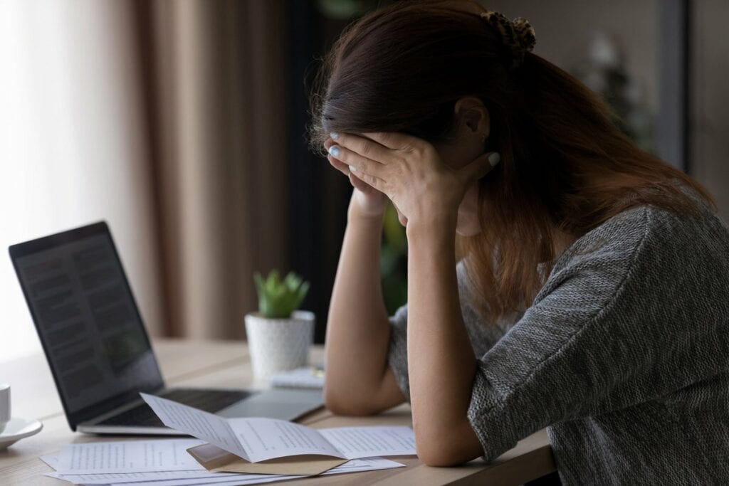 Woman appearing upset with head in her hands .width qqzych.jpg