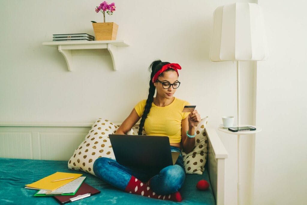 Woman relaxing at home looking at a credit ca.width cRZ.jpg