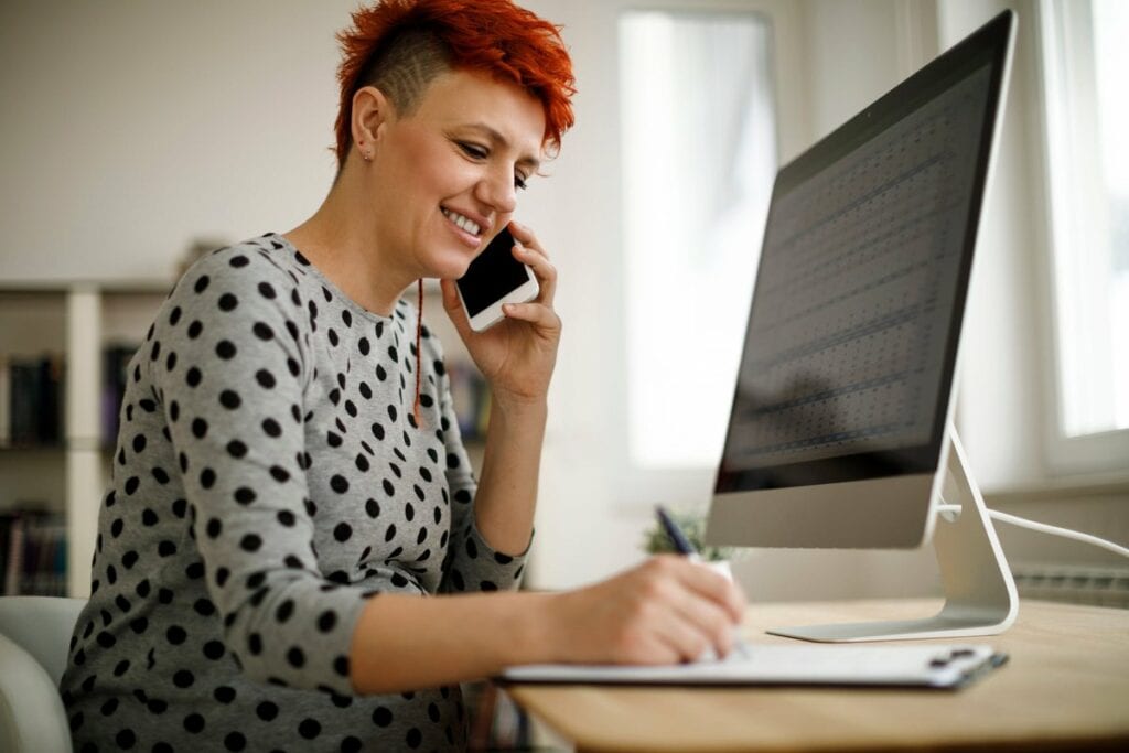 Woman working from home using computer phone .width Zsod.jpg