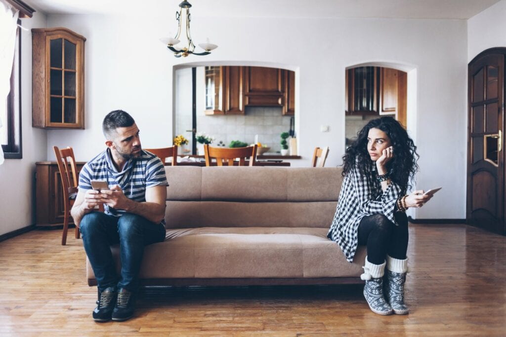 man and woman sitting at opposite ends of a c.width okzr.jpg
