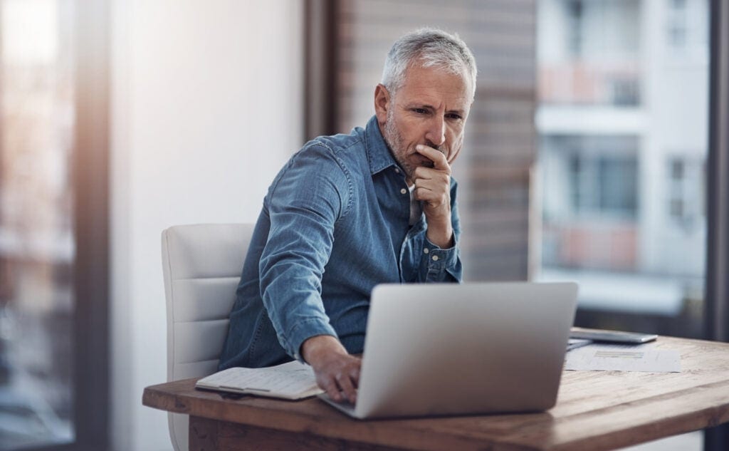 older man denim shirt laptop gettyimages .jpg