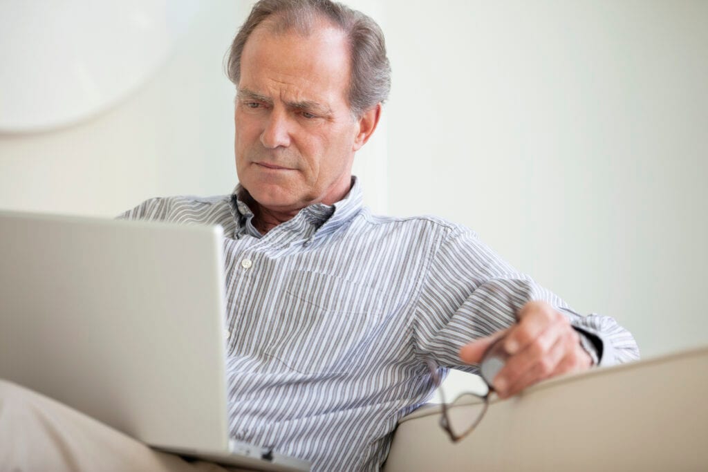 older man laptop serious expression looks unhappy gettyimages .jpg